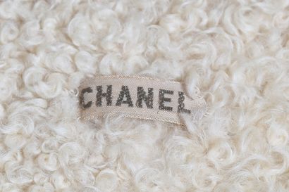 CHANEL Un manteau Chanel couture ivoire en tweed bouclé et doublé d'agneau de Mongolie,...