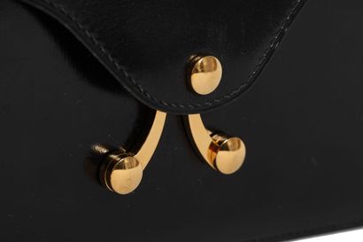 HERMES An Hermes black box leather handbag with gold scissor clasp, circa 1970

An...