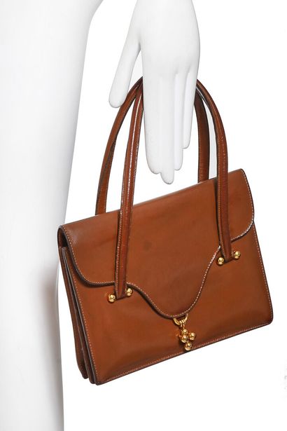 HERMES A Hermes tan leather bag from the 1960s,

An Hermès tan leather bag 1960s,

stamped,...