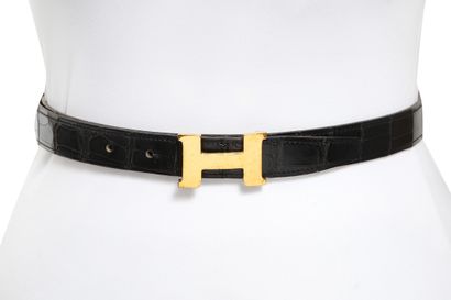 HERMES An Hermès embossed black leather belt with gilt 'H' buckle, 1988,

An Hermès...