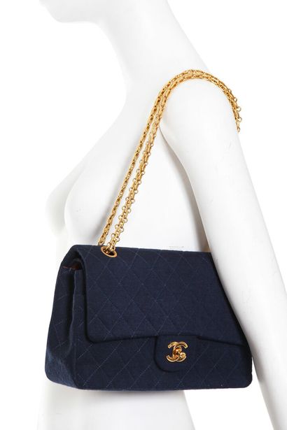 CHANEL A Chanel quilted navy jersey re-issue flap bag, 1989-91,

A Chanel quilted...