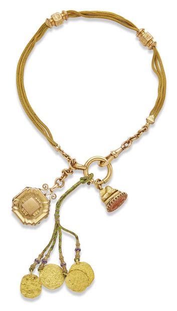 null Metal chatelaine and gold charms

The metal chain, including a seal decorated...