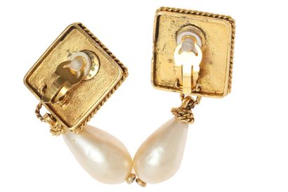CHANEL Pair of earrings, circa 1984

signed, with red cabochons set in square gilt...