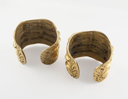YVES SAINT LAURENT Pair of open cuff bracelets with crocodile skin pattern, signed...