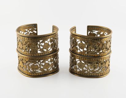 Pair of open cuff bracelets in pierced metal...