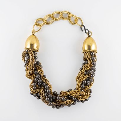 ATTRIBUE A YVES SAINT LAURENT Necklace in gold and silver metal made of a twist of...