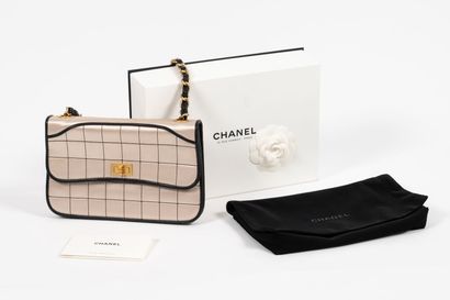 CHANEL Black leather and champagne satin bag with gold metal and black leather chain,...