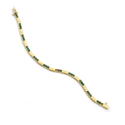 BRACELET An 18k gold and emeralds bracelet, composed of lines of three round emeralds...