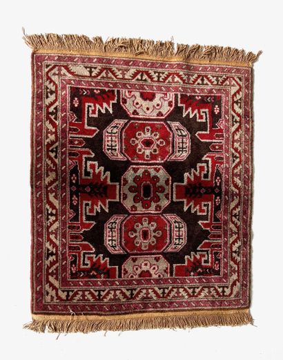 null RUGS OF THE EAST 

Dagestan carpet, XXth century, red and brown tones, triple...