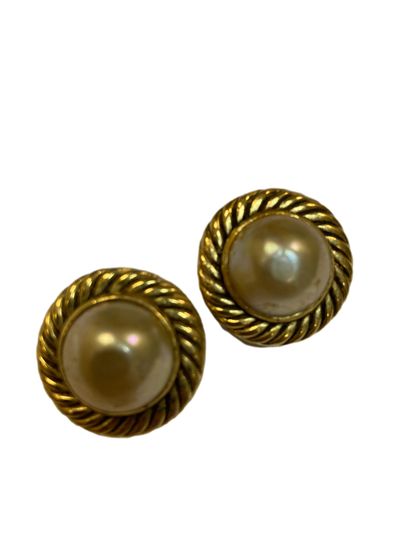 null CHANEL
Paire de clip d’oreilles en métal doré torsadé accueillant deux perles...