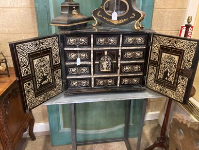 null Cabinet in blackened wood, richly inlaid with bone, with an architectural front....