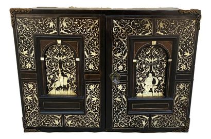 null Cabinet in blackened wood, richly inlaid with bone, with an architectural front....