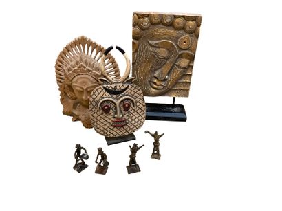 null Travel souvenirs including an Indonesian wooden mask, a wooden Buddha head,...