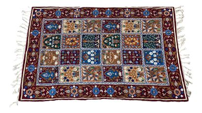 null Suzani embroidery rug of plants, flowers and foliage in a garden surrounded...