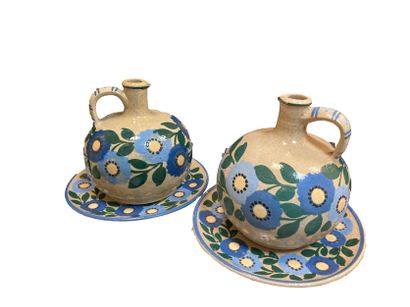 null Jean GARILLON (1898-1981)
Pair of enameled stoneware pitchers and display stands...
