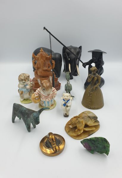 null Lot including two elephants in wood, a fisherman in wood, a representation of...