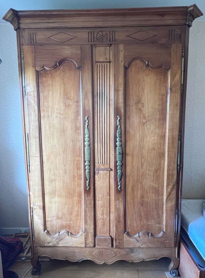 null Cabinet in natural wood molded and carved opening with two doors. 

Work of...