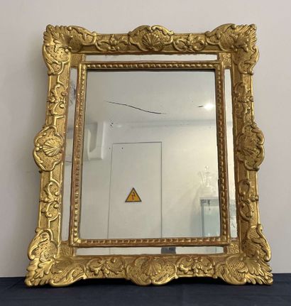 null Mirror with parecloses, gilded stucco frame decorated with shells and foliage....