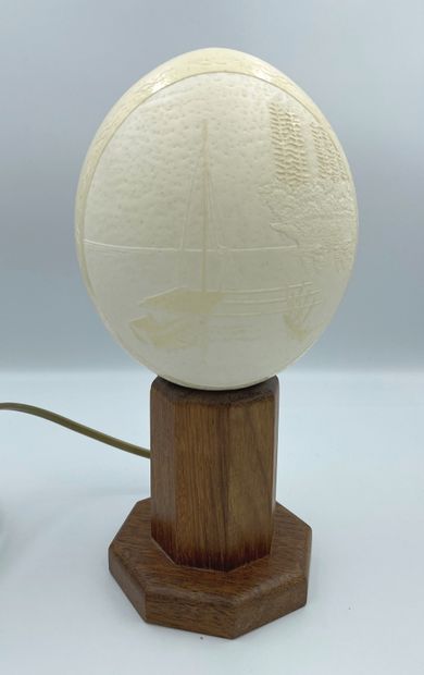 null Ostrich egg mounted in a lamp with engraved decoration of a lake scene

H. 25...