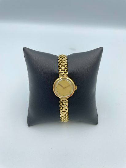 Bracelet-montre de dame en or jaune 18 carats...