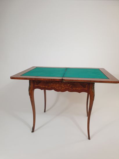 null Rosewood veneer and floral marquetry game table. Swiveling and folding top revealing...