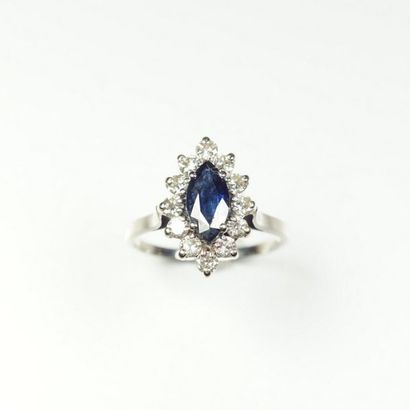null Marquise ring centered with a shuttle-cut sapphire in a setting of brilliant-cut...