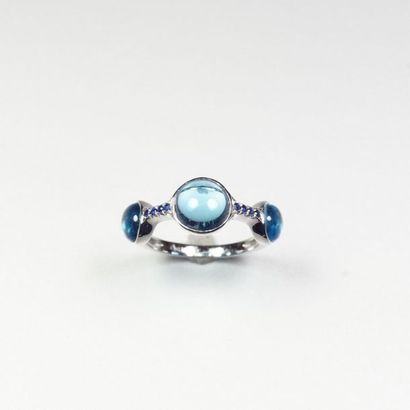 null 18K (750/oo) white gold ring set with three closed-set blue topaz cabochons...