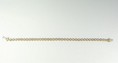 null Bracelet ligne en or jaune 18K (750/oo) à maillons ronds articulés, chacun centré...
