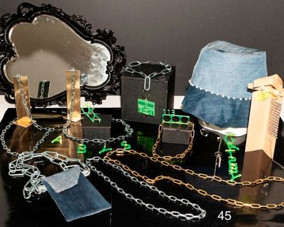 null Gansta" collection in chains and laser-cut plexi: 3 necklaces, 1 harness, 1...