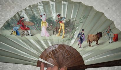 null FAN FOLDED ON ALMOND GREEN SILK. Beech wood strands and plumes finely carved...