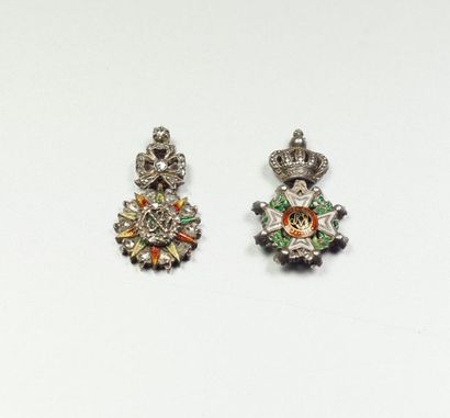 Two small charms depicting military decorations...