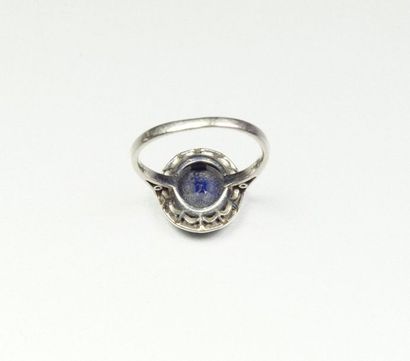null Platinum ring (850/oo) centered on an oval sapphire calibrating approximately...