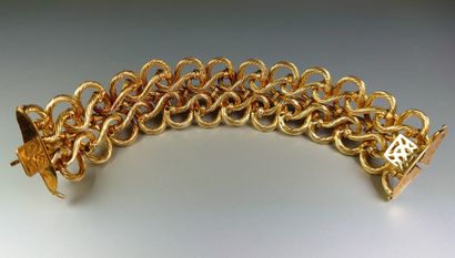 null 
Bracelet ruban articulé semi rigide en or jaune 18K ( 750°/°° ) à décor de...