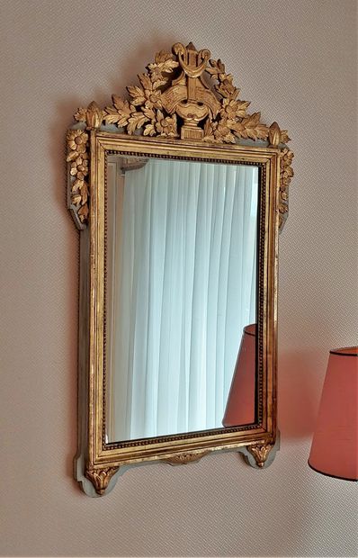 null A small Louis XVI style lacquered and gilded wood mirror decorated with a crown...