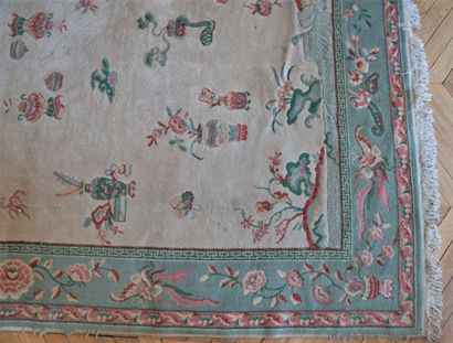 null Chinese carpet decorated with polychrome vases on a cream background (wear and...