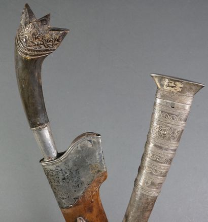 null Lot of two daggers: - One of large size. Carved horn handle with silver-plated...