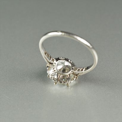 null Antique platinum (850/oo) ring centered with a half-cut diamond weighing 4.19...