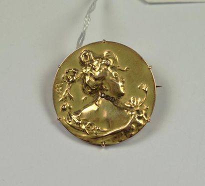 null Broche ronde en or jaune 18K (750/oo) à décor de profil de femme agrémenté de...