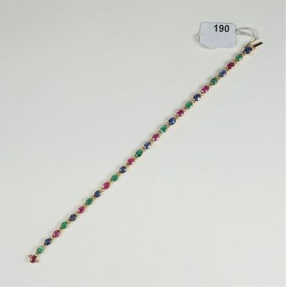 null Bracelet ligne en or jaune 18K (750/oo) agrémenté de rubis, d'émeraudes et saphirs...