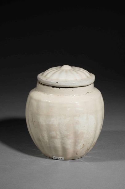 null Cizhu covered pot molded of gadroons in porcelain stoneware with a beige monochrome...