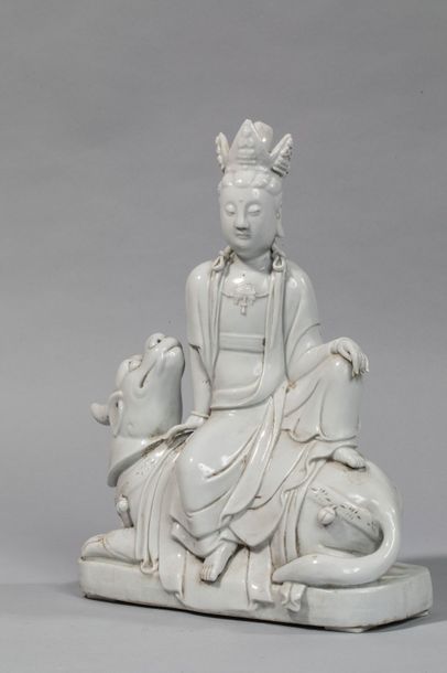 null The Boddhisattva Kwan Yin sits relaxing on a kilin, wearing the monastic robe,...