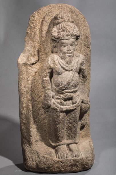 null Stele illustrating bearded Shiva, wearing an ascetic's bun held by a tie, standing...