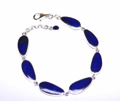 null Solid silver bracelet decorated with lapis lazuli with stylized shapes and iridescent...