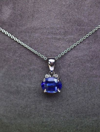 null White gold pendant centered on a NATURAL oval tanzanite weighing 4.90 c. enhanced...