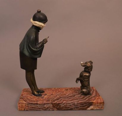 null CHRYSELEPHANTINE SCULPTURE "SMALL GIRL PLAYING WITH HER DOG" by André Vincent...