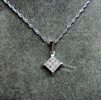 null A pendant in the shape of a "diamond" set with 9 diameters (G VS) in invisible...