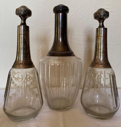 null BATCH OF THREE CRYSTAL CARAFES - With silver metal collars and silver -