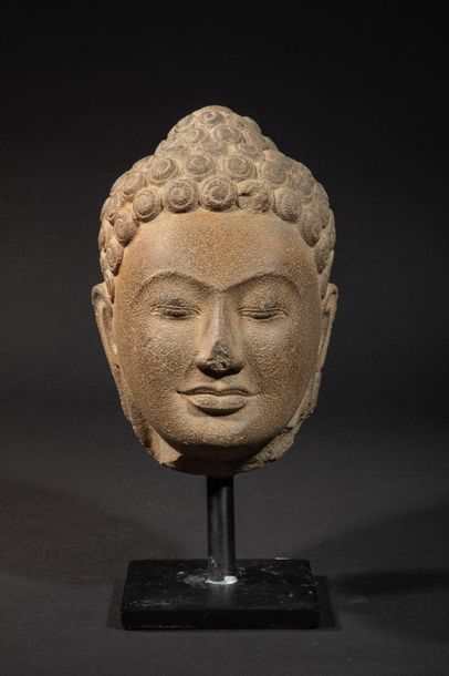 null Buddha's head with a serene expression and large curls chiselled into spirals,...