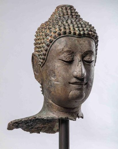 null Buddha's head with a serene expression, half-closed eyes suggesting an inner...