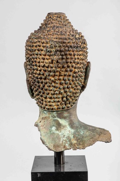 null Buddha's head with a serene expression, half-closed eyes suggesting an inner...